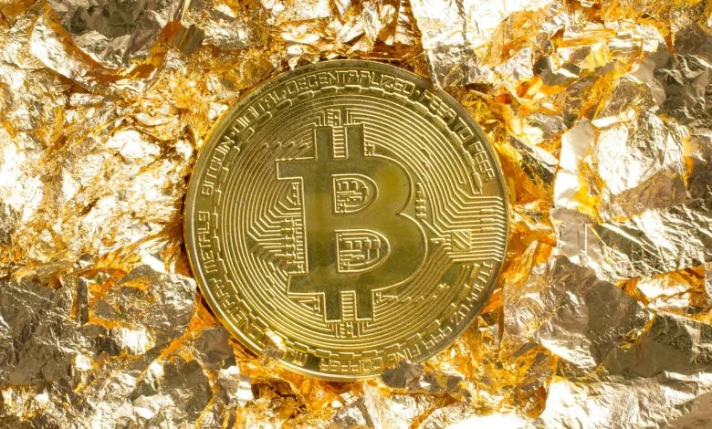 a gold coin with a bitcoin symbol on it