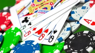 a close up of playing cards and poker chips